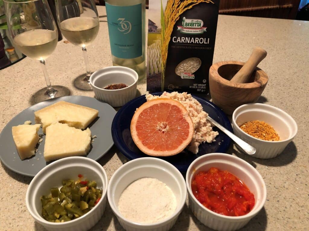 Ingredients for healthy roasted pepper risotto including carnaroli rice, grapefruit, burro acido, ground pepper skins, parmeggiano reggiano cheese.