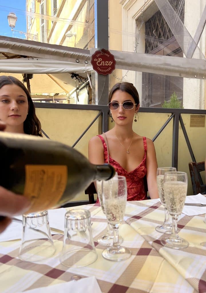 Prosecco being poured into glasses at Da Enzo in Trastevere.