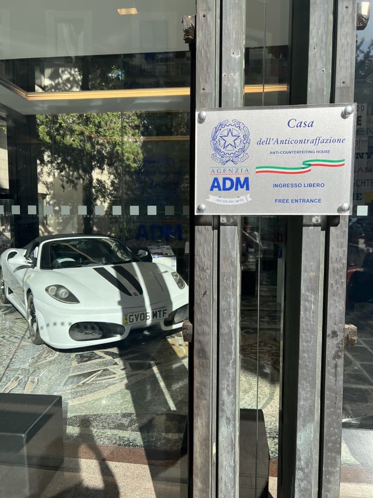 Casa dell'anticontraffazzione with a conterfeit Ferrari in the window in Trastevere.