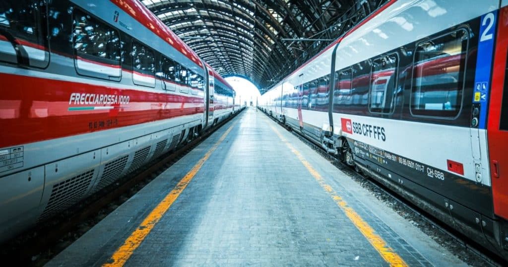 Red and white trains in Milan Central Station. The Milan Bergamo connection is strong with fast trains running every hour.