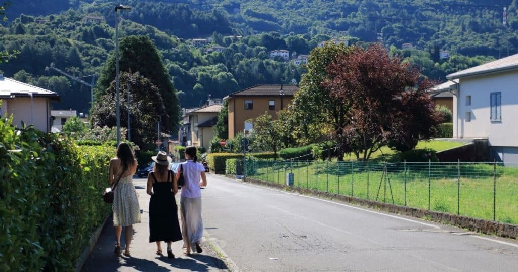 Three American women walking in their ancestors' town in Casazza, Italy. Having a guide on the ancestry tour helps.