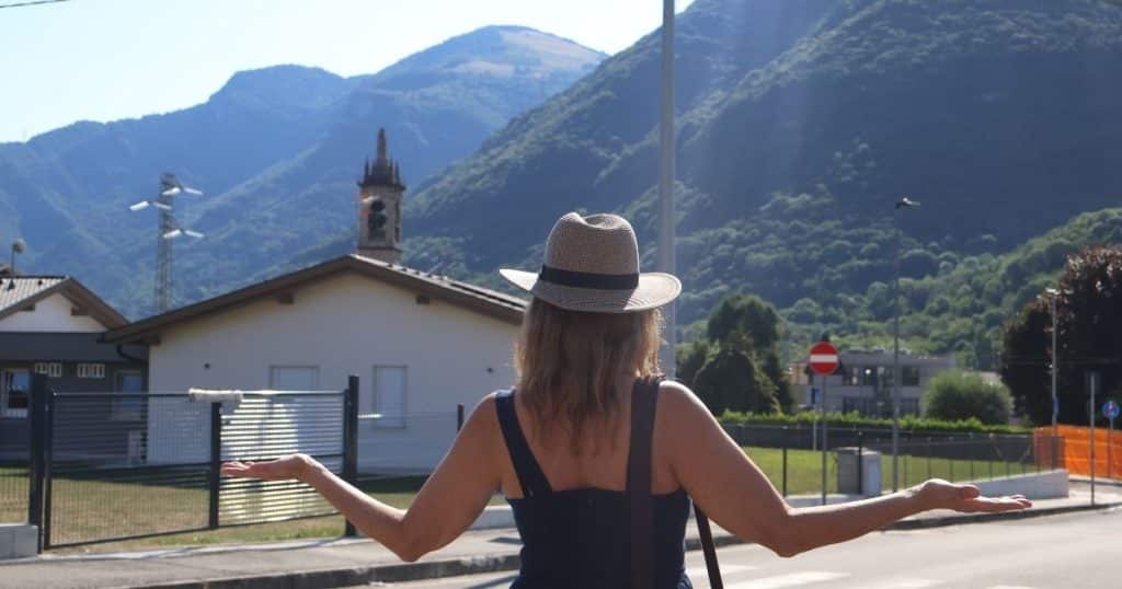 Woman with arms out showing happiness at gazing at the beautiful landscape of her ancestors.