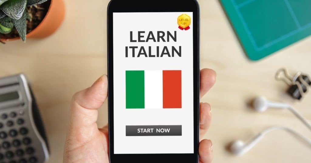 Person holding a phone displaying an Italian language learning app. Can Duolingo make you fluent in Italian