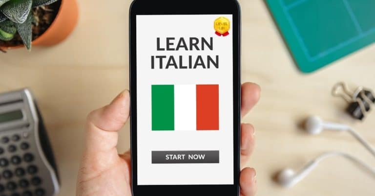 Person holding a phone displaying an Italian language learning app.