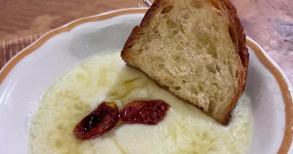 Melted caciocavallo cheese with roasted tomatoes and a slice of pane pugliese at Il Mannarino