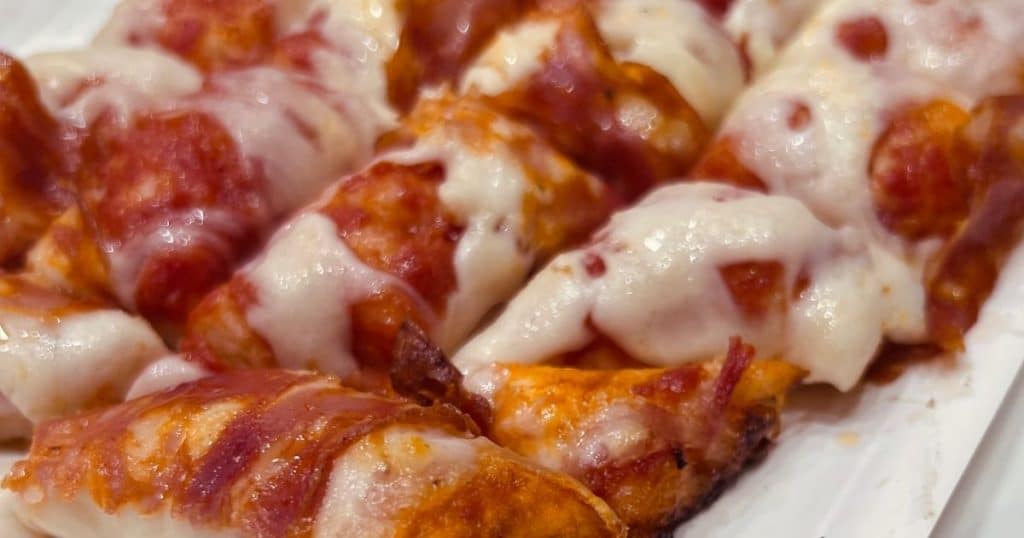 Close-up of traditional pepperoni and mozzarella pizza al trancio slices at il Forno
