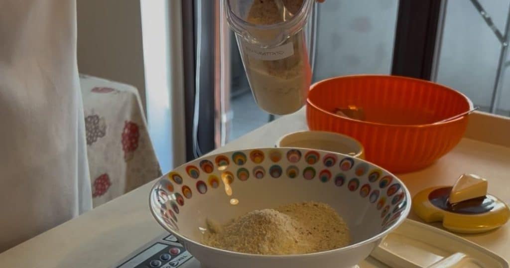 Bowl with parmesan cheese and breadcrumbs on a scale to make to filling of the Scar[inocc ravioli.