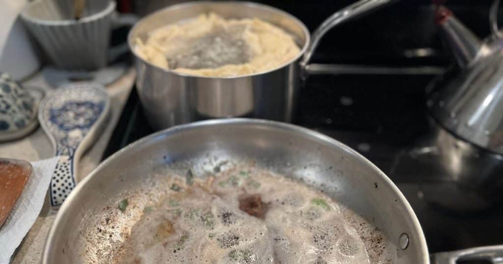Butter and sage browning in the foreground, pasta boiling in the background.