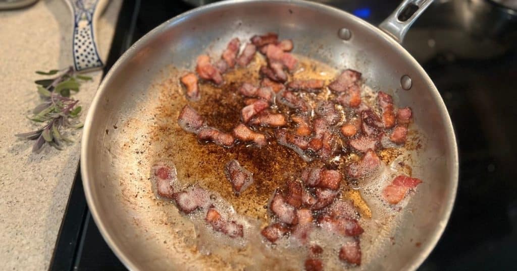 Cut bacon crisping in a pan.